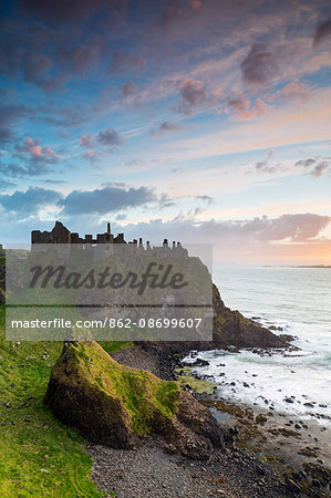 United Kingdom, Northern Ireland, County Antrim, Bushmills. The ruins of the 13th century Dunluce Castle.