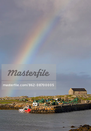 Scotland, Argyll and Bute, Isle of Tiree. Stormy sky and rainbow at Scarinish Harbour.