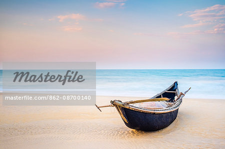 Traditional bamboo basket fishing boat on the beach at sunset, Thuan An Beach, Phu Vang District, Thua Thien-Hue Province, Vietnam