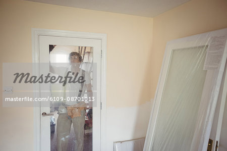 Carpenter fixing a door at home