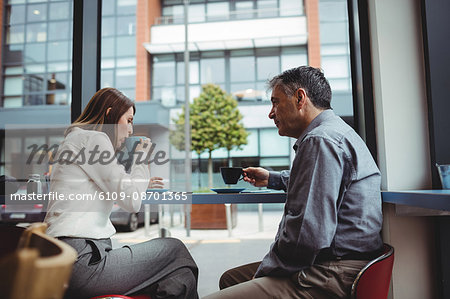 Man and woman having coffee in the cafeteria