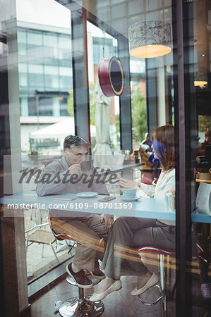 Man and woman having coffee in the cafeteria