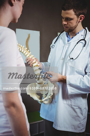 Physiotherapist explaining the spine to patient in the clinic