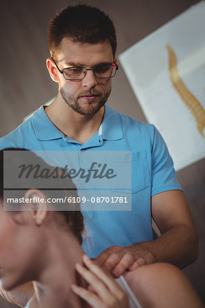 Physiotherapist stretching neck of a female patient in the clinic