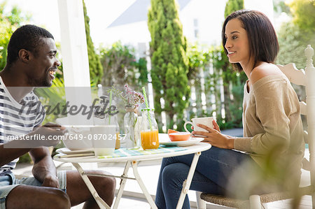 Young couple sharing eating breakfast together