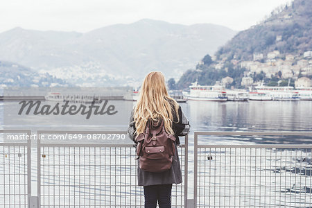 Rear view of young woman looking out at Lake Como, Italy