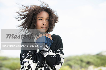 Young woman feeling cold in wind