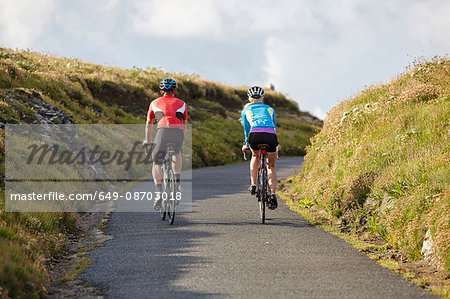 Cyclists riding on country road