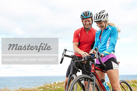 Cyclists stopping to use GPS on mobile phone