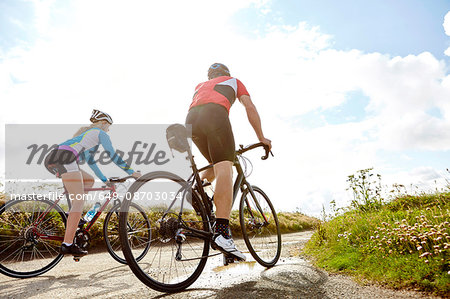 Cyclists riding on country road