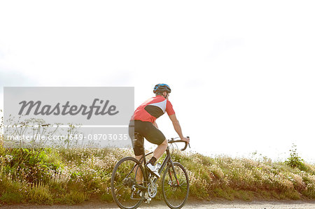 Cyclist riding on country road