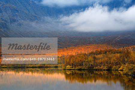 Autumn color and low cloud at Maliy Vudjavr Lake, Khibiny mountains, Kola Peninsula, Russia