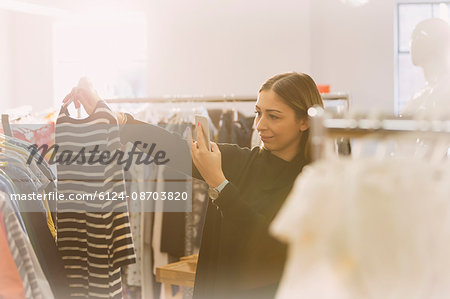 Fashion buyer photographing striped shirt