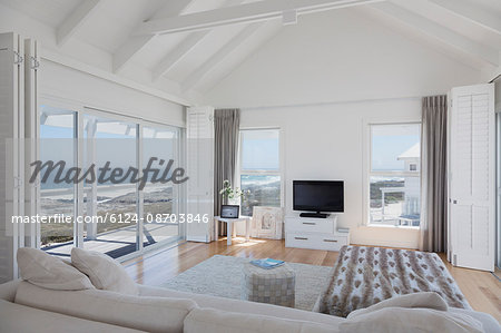 Wood beam vaulted ceiling living room in home showcase beach house