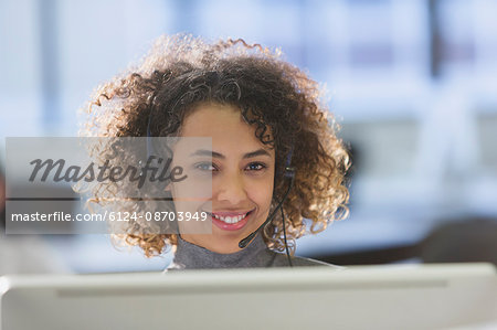Portrait confident businesswoman with headset in office