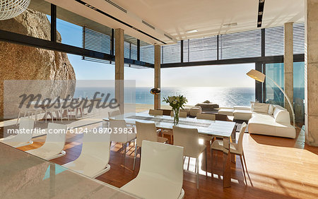 Modern luxury home showcase dining room and living room with sunny ocean view