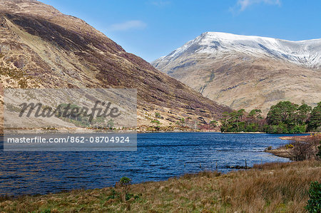 General view of the Sheeffry Hills near Leenauan with Fin Lough in the foreground and a snow capped, Barrclashcame Mountain (highest peak in the Sheeffry Hills) in the background , Liscarney, Co. Mayo, Ireland.