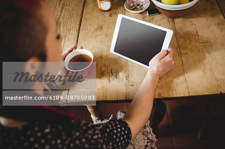 High angle view of young woman using digital tablet at home