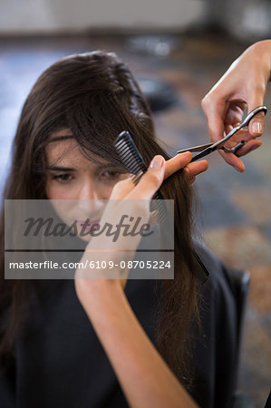 Female getting her hair trimmed at a salon