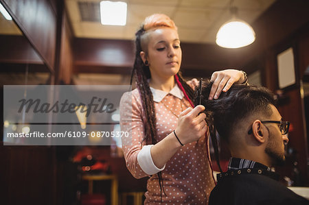 Man getting his hair trimmed in barber shop