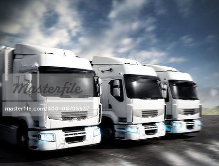 Three white articulated trucks on the road