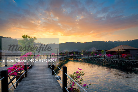 Overwater bungalow at dusk.Beautiful sunset over beach with water villas.Summer vacation concept