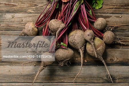 Freshly harvested red beets on a wooden table