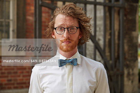 Portrait of young man outdoors, wearing shirt and bow tie