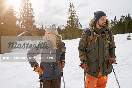 Couple snowshoeing across snowy landscape, Elmau, Bavaria, Germany