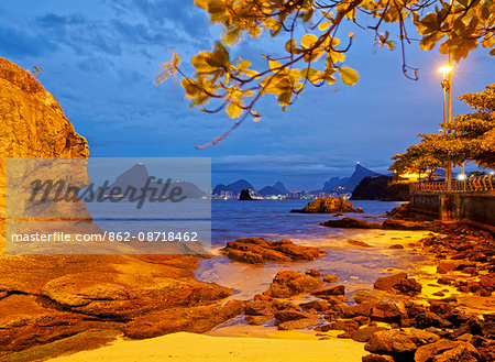 Brazil, State of Rio de Janeiro, Niteroi, Twilight view of the Beach with Skyline of Rio de Janeiro in the background.