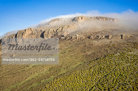 Ethiopia, Oromia Region, Bale Mountains, Sanetti Plateau. Early morning mist lifts from the high altitude Sanetti Plateau as the sun rises.