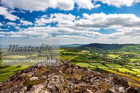 A couple take in the panoramic view of the Garden of Ireland, Co. Wicklow, looking south towards Co. Wexford, viewed from the Little Sugar Loaf, Kilruddery Deerpark, Co. Wicklow, Ireland.