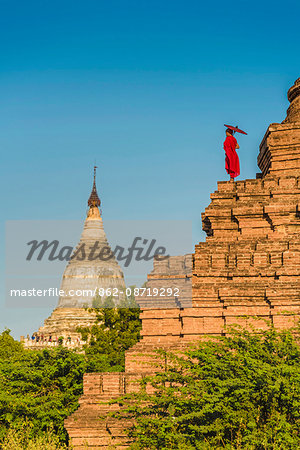 Bagan, Mandalay region, Myanmar (Burma). A young monk watching the Shwesandaw pagoda.