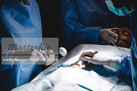 Surgeons performing operation in operation room at the hospital