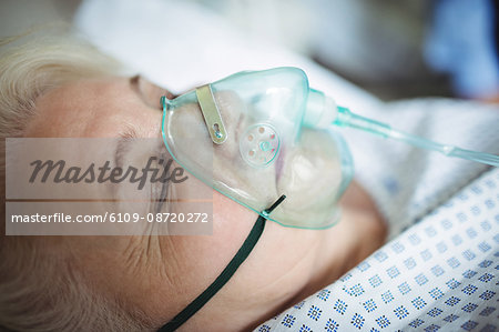 Senior patient with oxygen mask in hospital