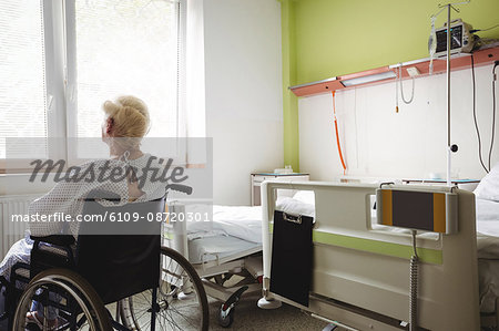 Senior woman sitting on wheelchair at hospital