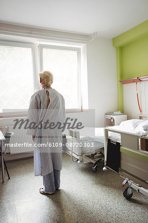 Senior woman standing in hospital ward