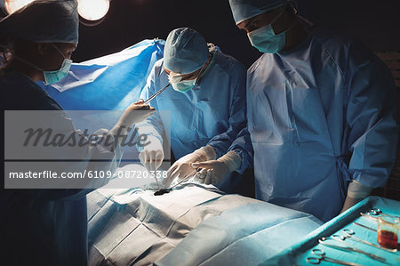 Surgeons performing operation in operation room at the hospital