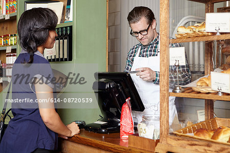 Customer in bakery paying for goods