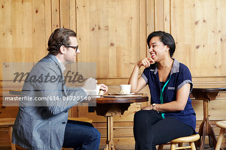 Man and woman sitting in cafe drinking coffee