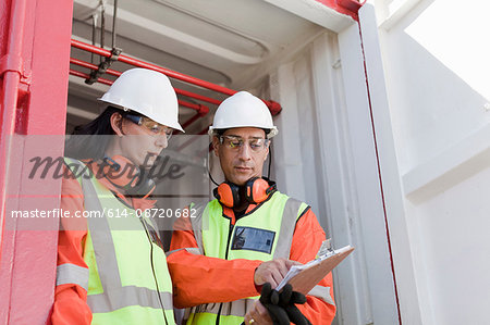 Engineers in discussion on oil rig