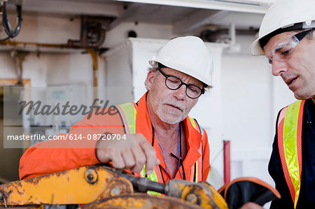 Engineers in discussion on oil rig