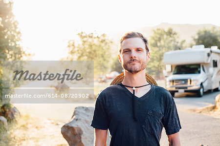 Portrait of man by camper van looking at camera, Malibu Canyon, California, USA