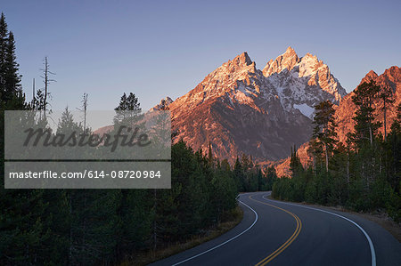 Winding road through mountain landscape, Grand Teton National Park, Wyoming, USA