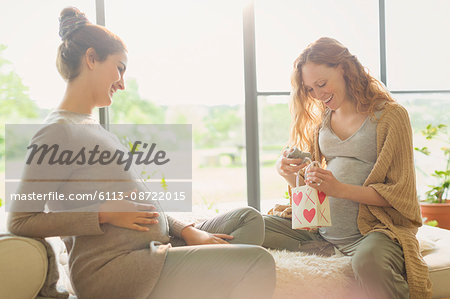 Pregnant women opening gifts Pregnant women opening gifts