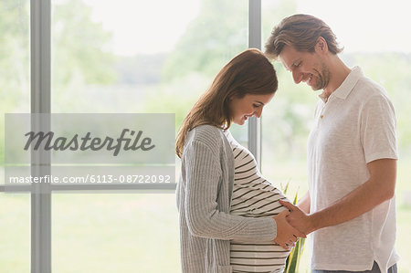 Affectionate pregnant couple touching stomach