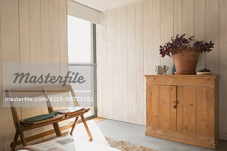 Chairs and cabinet in sunny room