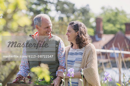 Smiling couple shopping in plant nursery garden