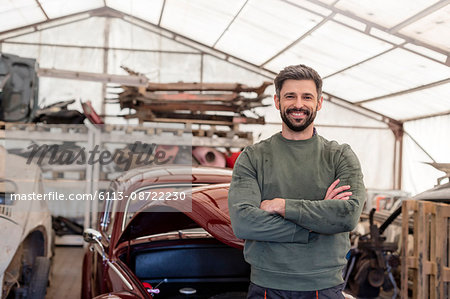 Portrait confident mechanic in auto repair shop