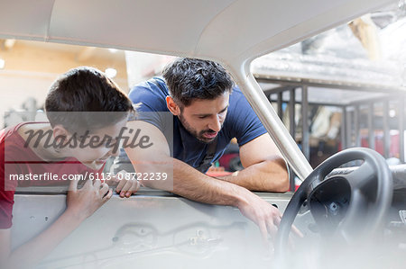 Father and son rebuilding classic car